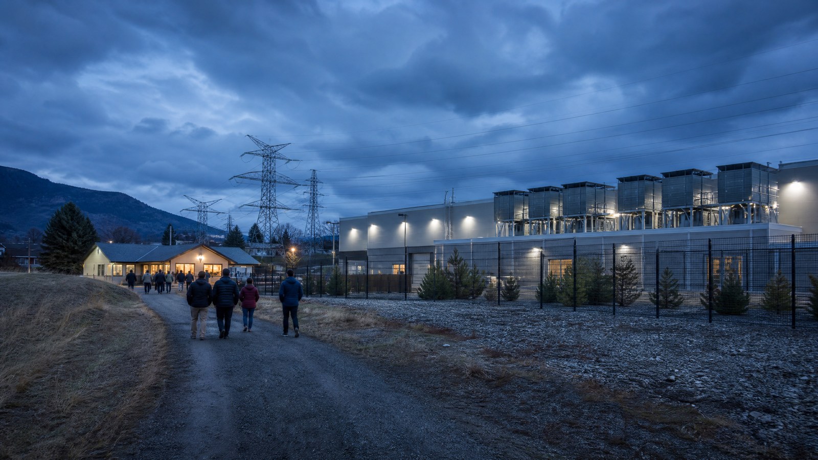 Unbranded data-centre campus near a small town at dusk